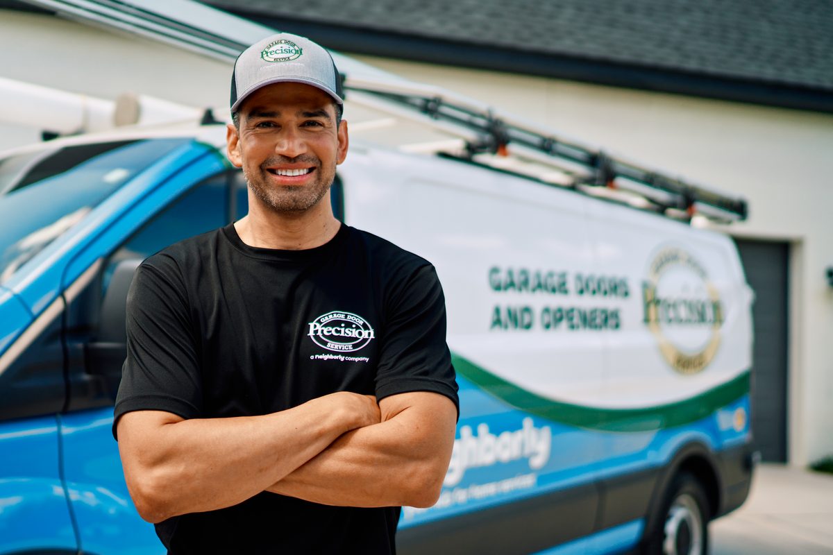 Precision Garage Door technician performing spring repair in Des Moines, IA